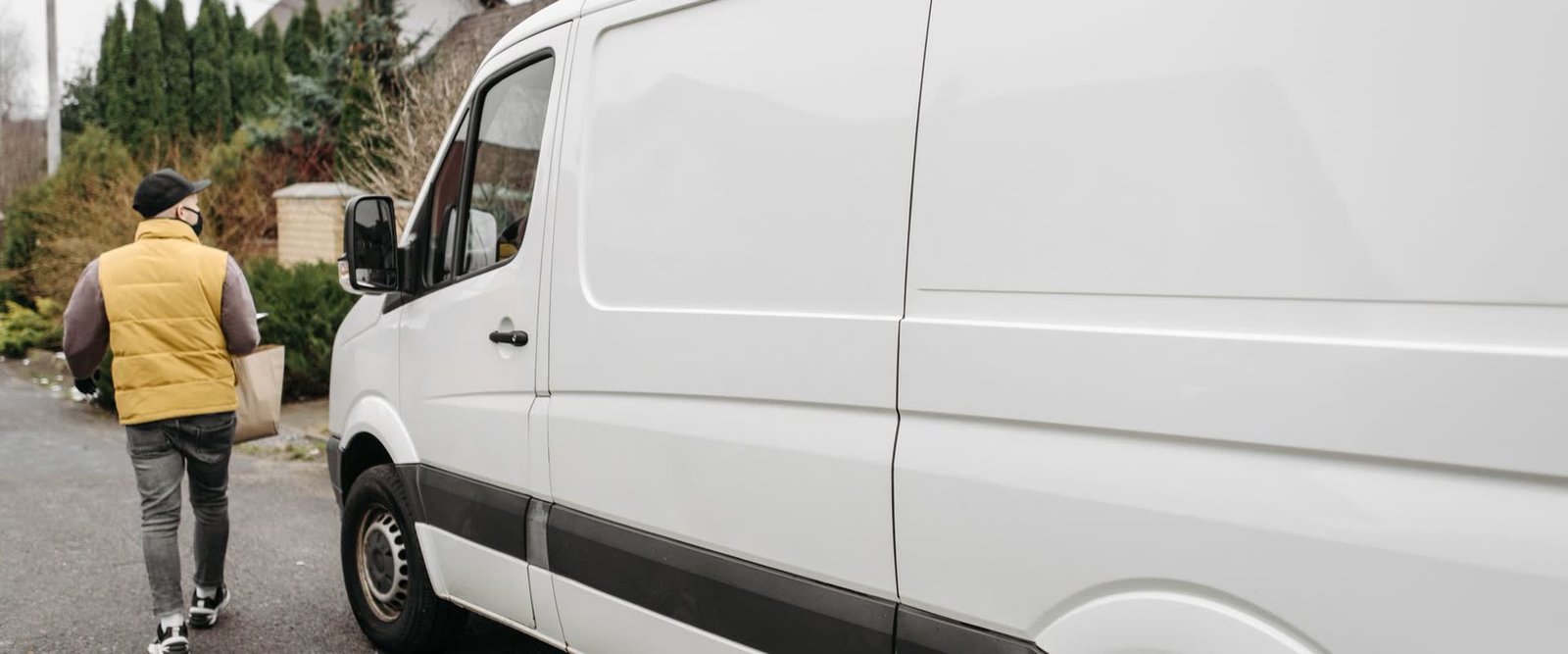 Courier van delivering a parcel to a residential address