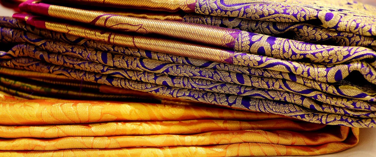 Folded silk sarees of the kind customers order from Indian stores and ship abroad